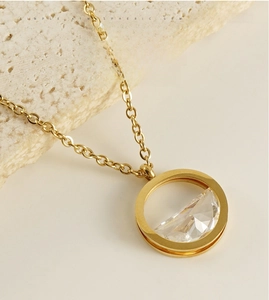 Detailed close-up of 18K gold-plated stainless steel necklace with clear zircon pendant