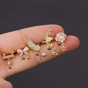 Detail of five gold rings with cubic zirconia charms featuring bow and butterfly designs