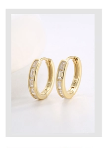 Detailed close-up of S925 hallmark on gold earrings with rectangular zircon stones