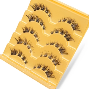 Five pairs of fox-style false eyelashes with criss-cross patterns on a yellow tray