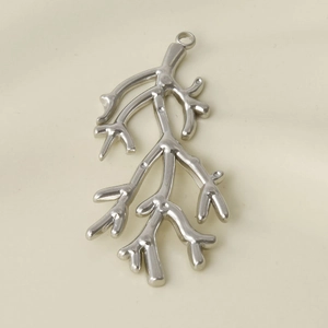 Macro detail of silver stainless steel coral branch pendant with a small hanging ring
