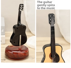 Detailed view of a vintage guitar music box featuring a rotating wood grain base and strings