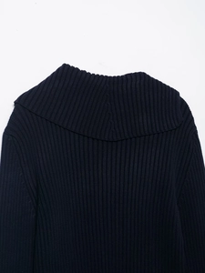 Close-up of navy blue ribbed knit texture and lapel collar design on women's sweater