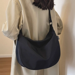 Waterproof black nylon dumpling crossbody bag with adjustable wide strap for women