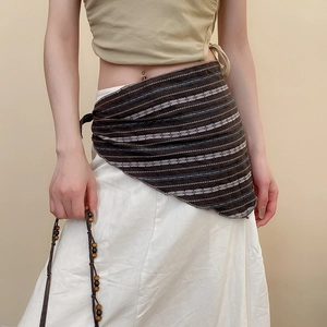 Detail view of bohemian brown striped linen hip scarf with asymmetric draped edges