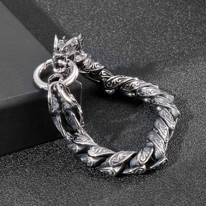 Detail of vintage silver dragon head clasp on heavy engraved stainless steel chain