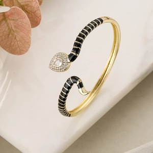 Bohemian gold snake bracelet with black enamel scales and shimmering zircon stones