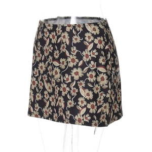 Close-up of floral print A-line mini skirt featuring beige flowers on a black background