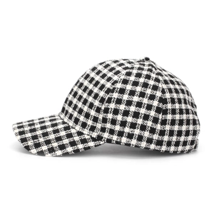 Detail of classic black and white houndstooth plaid fabric on a structured baseball cap