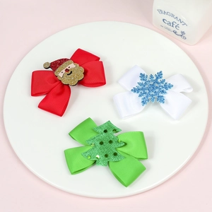 Detail of Christmas hair bow clips with Santa, snowflake and tree sequin decorations