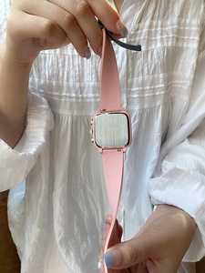 Detail of a 22mm pink silicone watch strap and square metal back of a stylish smartwatch