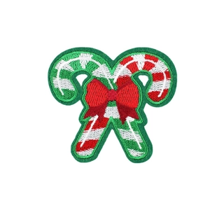 Christmas candy cane embroidery patch with red bow on a clean white background