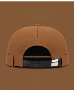 Detail of cotton docker hat with adjustable leather strap and metal buckle in brown