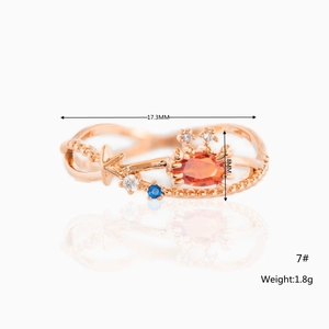 Detail view of rose gold crab ring with orange blue zircon stones and size 7 measurements