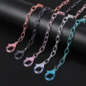 Close-up of five colorful translucent resin mask chains with large plastic lobster clasps