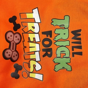 Detail of orange cotton dog t-shirt with 'WILL TRICK FOR TREATS!' Halloween print