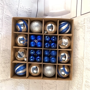 Detail of 16 mixed blue and silver Christmas balls in a kraft box for tree decoration
