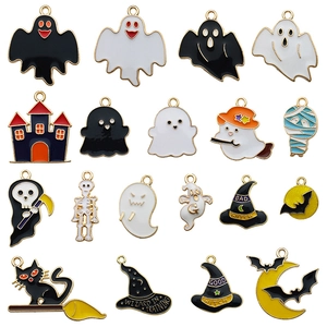 Set of 18 Halloween enamel charms including ghosts and pumpkins on white background