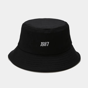 Classic black cotton bucket hat featuring white 1987 embroidery and reinforced brim