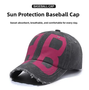 Detail of distressed grey washed denim baseball cap with pink embroidered B letter