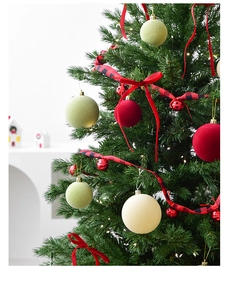 Flocked Christmas ball ornaments in red, green, and cream hanging on a festive tree