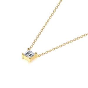 Detail of square-cut clear crystal pendant on a delicate gold-plated cross chain