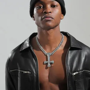 Close-up of hip hop silver cuban chain necklace with iced out inverted cross pendant on model