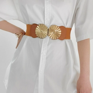 Detail of brown elastic waist belt featuring two textured gold metal round buckles on model