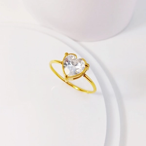 Minimalist gold titanium steel ring with heart shaped zircon in a three-prong setting