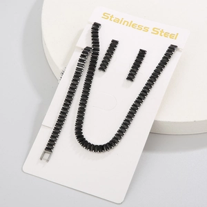 Detail of silver stainless steel jewelry set with black rectangular zircon stones on a white card