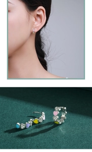 Detailed view of colorful enamel heart earrings with sparkling small diamonds on model