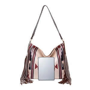 Detail view of large bohemian woven tote bag showing interior capacity and tassel accents