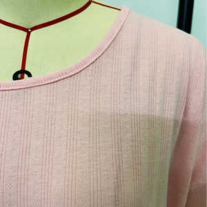 Pink knit long-sleeve pajama top with vertical ribbed texture and round neckline