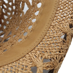 Detailed close-up of woven straw texture and sweatband on the beach sun hat