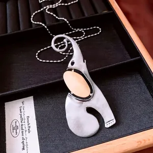 Abstract elephant pendant necklace in brushed stainless steel with gold metal accents