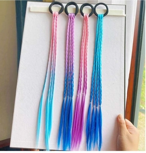 Detailed macro view of four colorful gradient synthetic hair extensions on elastic bands