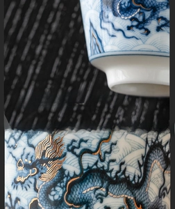 Detailed macro view of relief dragon motif and gold inlay on luxury ceramic teacup