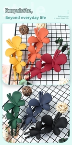 Macro detail of large matte butterfly hair clips in six elegant assorted colors