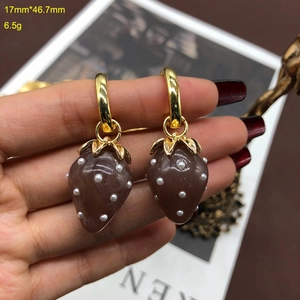 Detailed size view of strawberry pearl earrings measuring 17mm by 46.7mm in gold finish