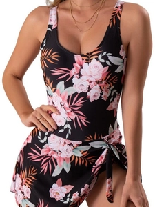 One-piece swimsuit with tropical floral print and matching sarong skirt in black
