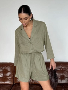 Detail of olive green linen shirt set showing natural fabric texture and drawstring waist