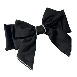 Elegant black satin triple bow hair clip with decorative pearl edges on white background