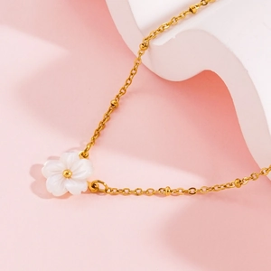 Elegant gold shell flower necklace with white petals and beaded chain for women