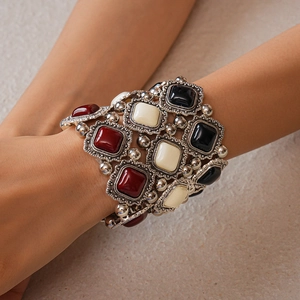 Detail of vintage bohemian wide bracelet with antique silver metal and colorful resin inlay