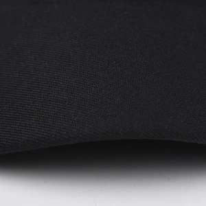 Close-up of the dense black knit fabric texture on the leopard chain newsboy cap