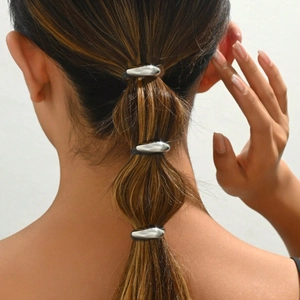 Three minimalist silver metal ponytail hooks hair accessories on model's hairstyle