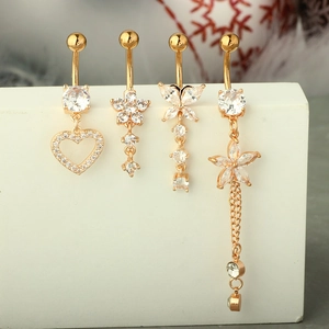 Detail view of gold-plated navel rings featuring zircon heart, flower, and butterfly motifs
