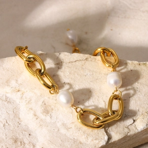 18K gold plated stainless steel bracelet with baroque pearls on a textured stone