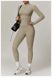 Detail of high waist yoga set with slim fit long sleeve half-zip top in olive green