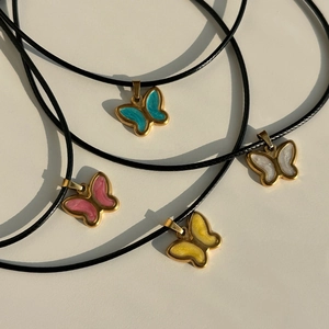 Set of four vintage butterfly necklaces with colorful enamel pendants on black cords